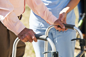 Midsection, healthcare worker helping senior man with walker