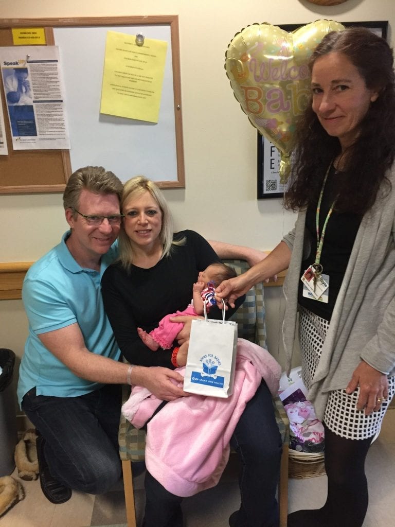Proud parents, Kristen and John Hayward get ready to leave Grand View Health with their new baby. Sheila Knerr, MD, Books for Babies program director and Children’s Hospital of Philadelphia (CHOP) pediatrician, presents them with a gift bag which is designed to promote literacy and help strengthen parent-child relationships.