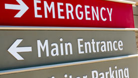 Close-up of map sign, EMERGENCY pointing right and Main Entrance pointing left.